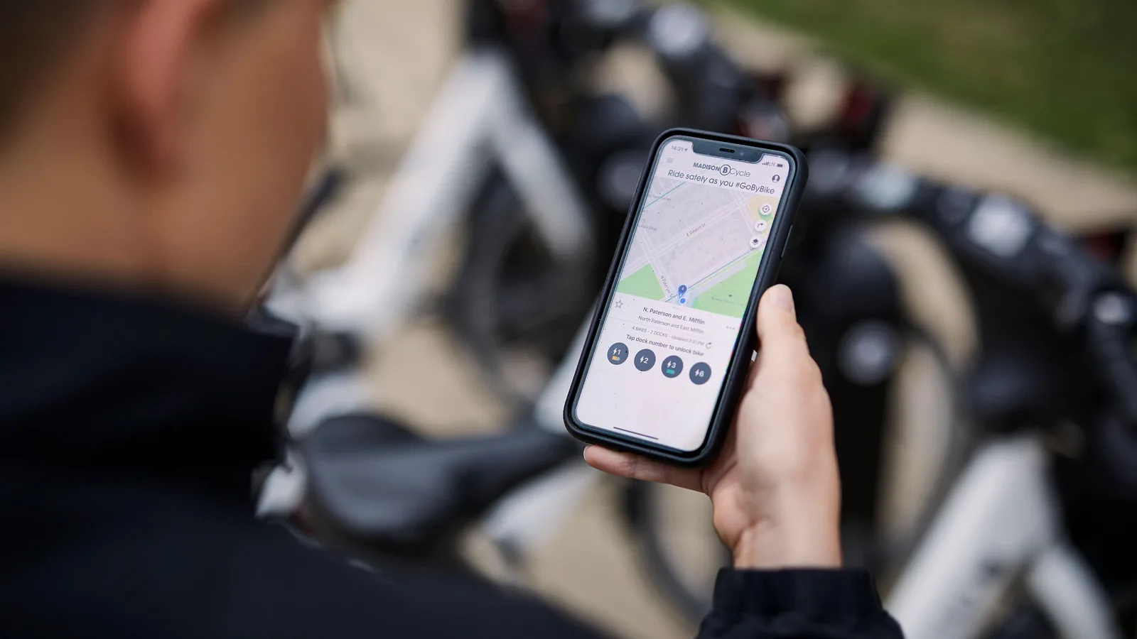 woman looking at her smart phone to access the BCycle app