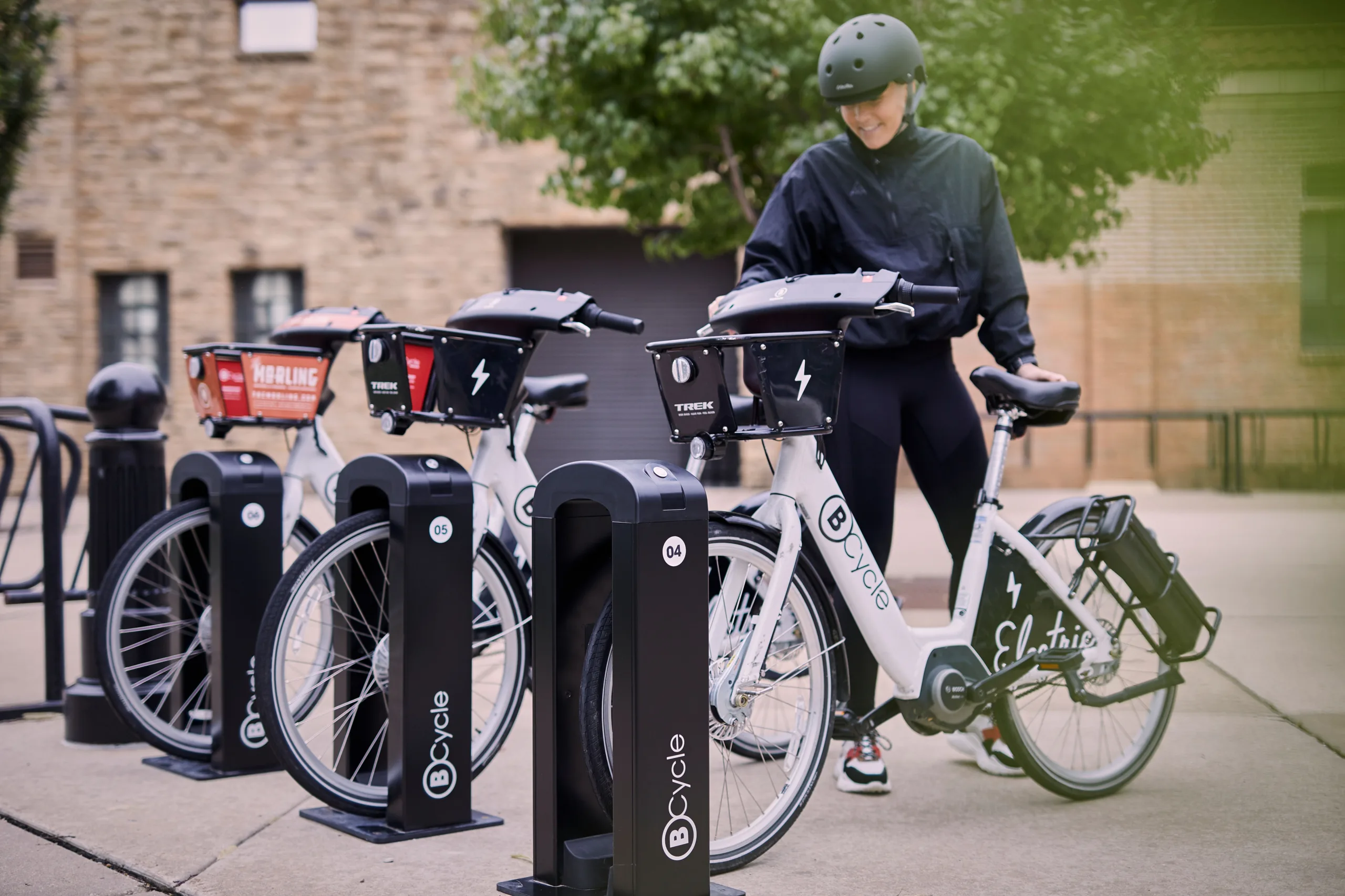woman undocking her bike share bicycle